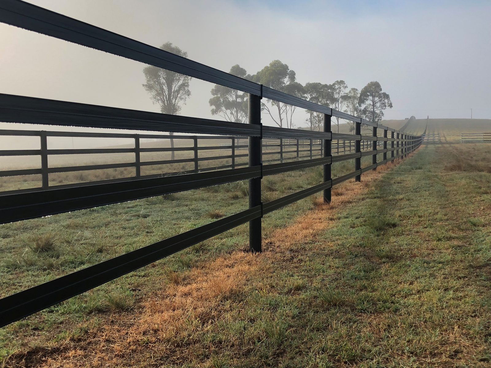 Horse-friendly black composite post-and-rail fencing